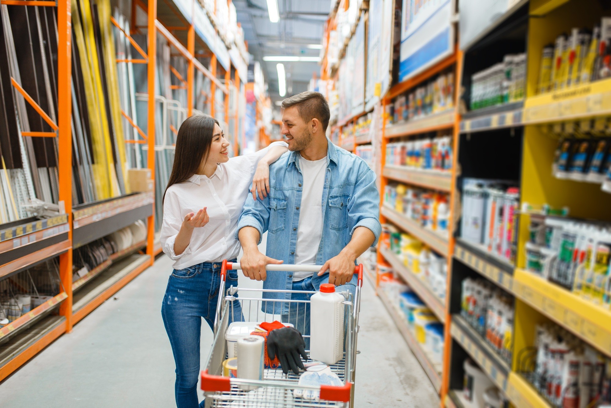 Couple with a cart buying building materials